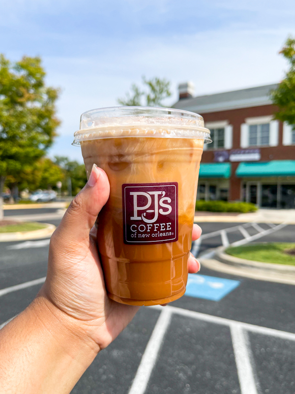 A hand holding a coffee drink from PJ's Coffee in Bowie, Maryland