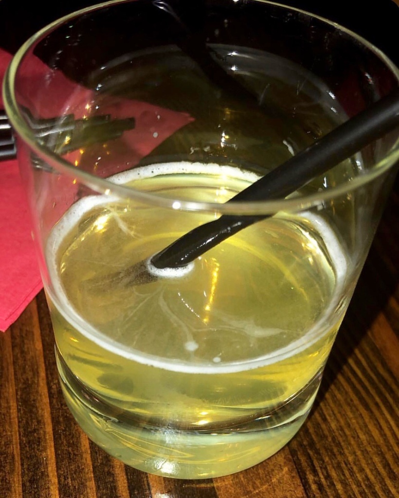 A glass of Limoncello on the table at Beatstro​, which is a restaurant located in the Bronx, New York City.