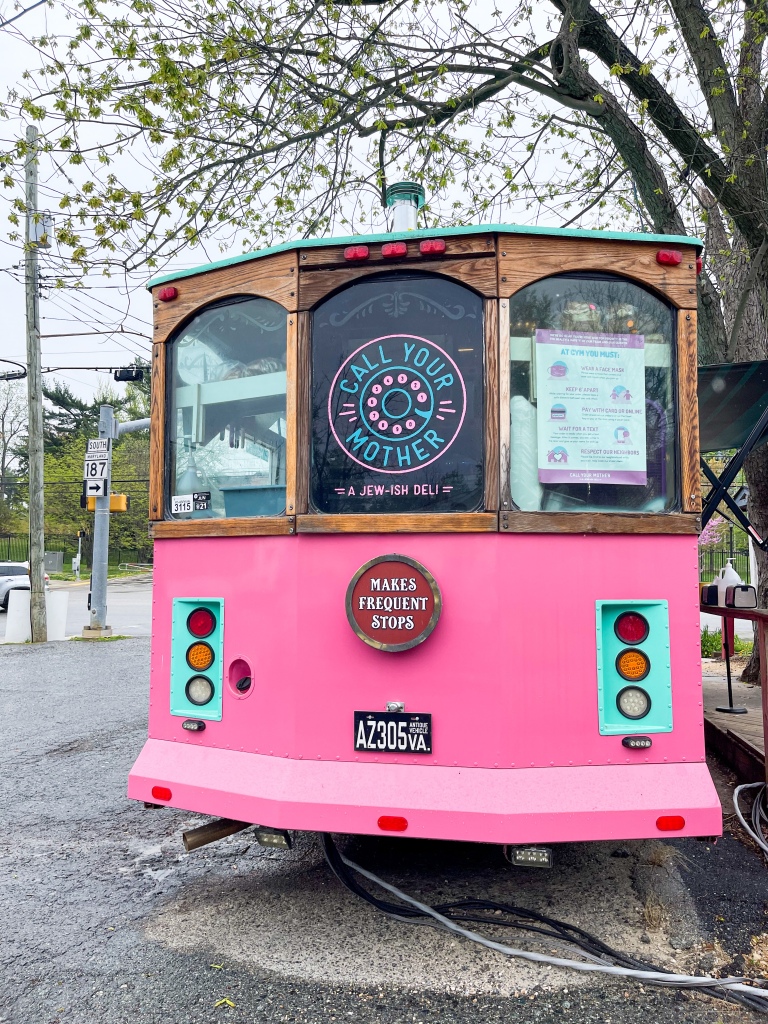 A pink and teal trolley in Bethesda, Maryland where Call Your Mother Deli sells food