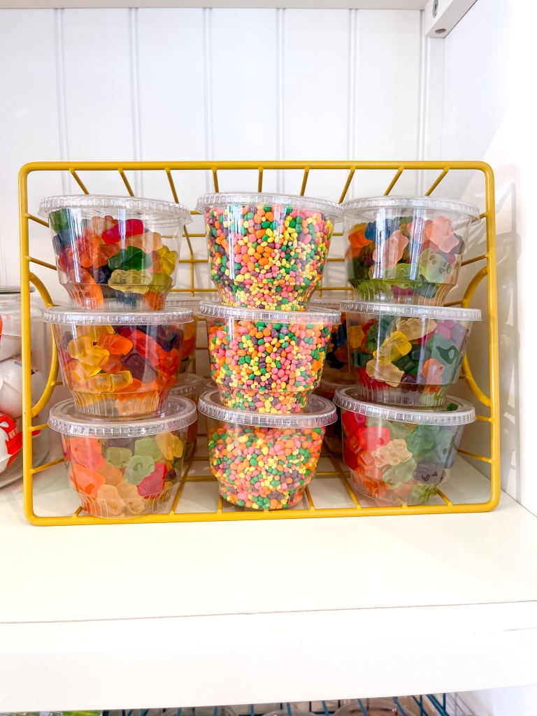 Various candies for ice cream toppings in plastic tubs